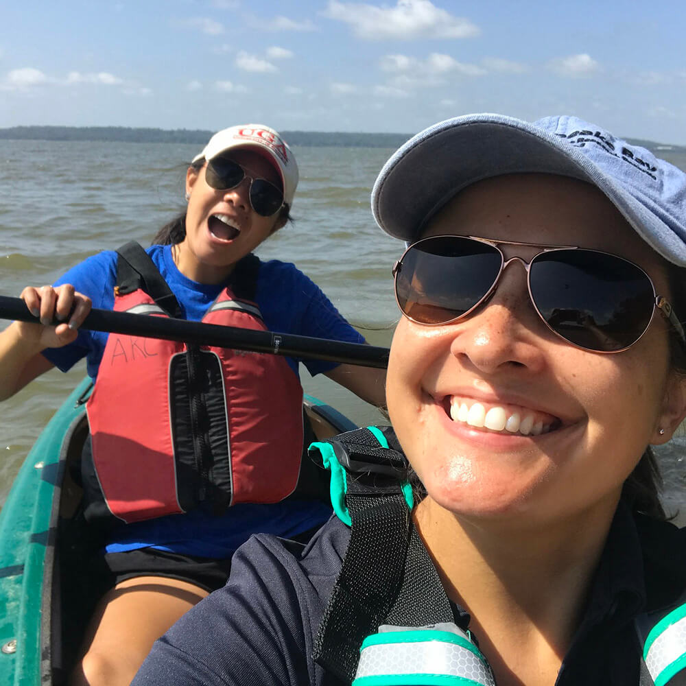 two people take a selfie from a tandem kayak on the water